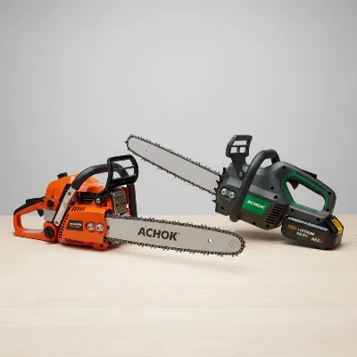 A side-by-side comparison of a gas chainsaw and a battery chainsaw, highlighting their distinct designs and power sources.